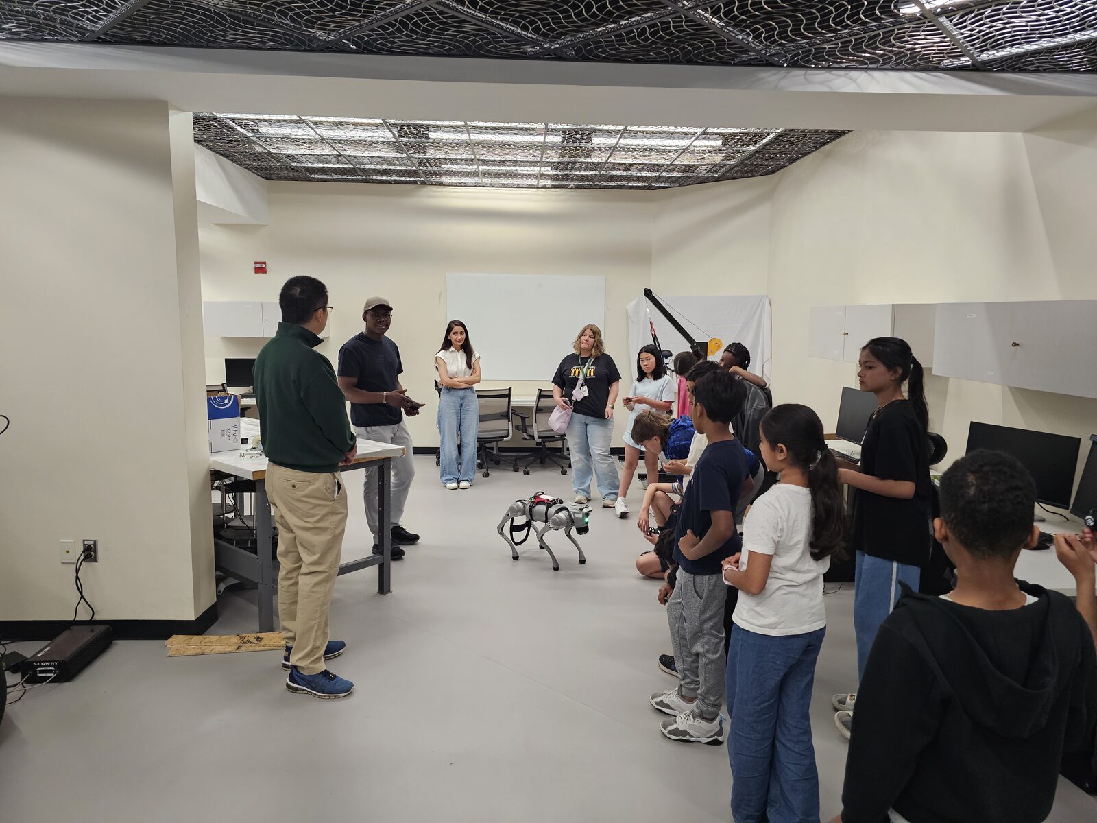 Showing the quadruped robot to students during the lab tour