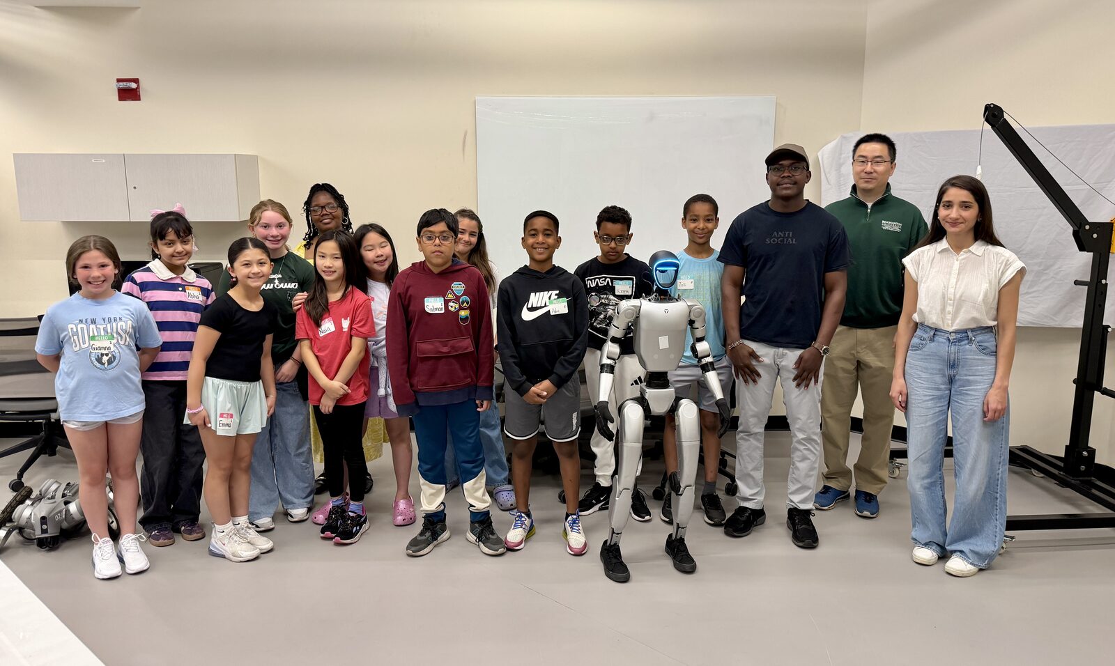 Group photo with the African Road Elementary students and the humanoid robot